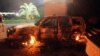 A vehicle sits smoldering in flames after being set on fire inside the US consulate compound in Benghazi late on September 11, 2012. 