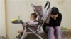 Syrian refugee with her baby near the border town of Wadi Khaled, Lebanon, May 2012.