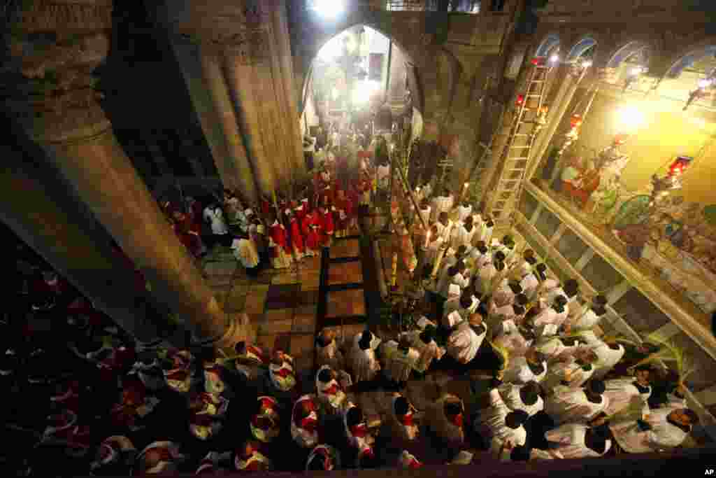Christian clergymen carry palm fronds during the Palm Sunday procession in the Church of the Holy Sepulcher, traditionally believed by many to be the site of the crucifixion, in Jerusalem's Old City.