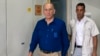 Former Israeli Prime Minister Ehud Olmert (L) arrives at the Tel Aviv District Court. May 13, 2014.