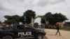 A police truck is stationed outside the University of Abuja Staff Quarters gate where unknown gunmen kidnapped two university professors, lecturers and their family members in Abuja, Nigeria, Nov. 2, 2021.
