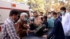 Residents and medics transport a Syrian Army soldier, wounded in what they said was a chemical weapon attack near Aleppo, to a hospital, March 19, 2013.