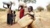 Children carry their family's belongings as they go to Yida refugee camp in South Sudan outside Tess village in the rebel-held territory of the Nuba Mountains in South Kordofan, May 2, 2012. 